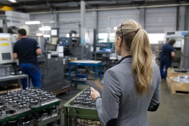 Industrial expert on a factory floor with tablet
